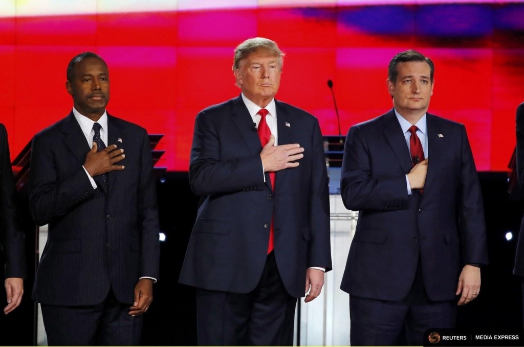 Republican U.S. presidential candidates Dr. Ben Carson Donald Trump and Sen. Ted Cruz held their hands over their hearts before Tuesday night's debate