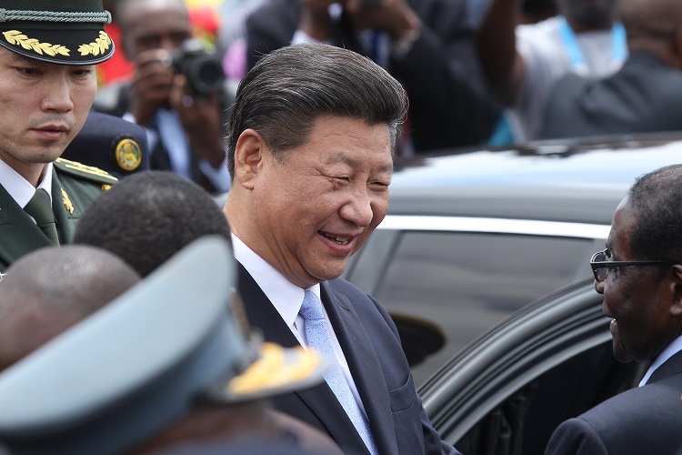 Chinese President Xi Jinping chats to Zimbabwean President Robert Mugabe right upon his arrival in Harare Zimbabwe Tuesday Dec. 1. 2015. Jinping is in Zimbabwe for a two day State visit during which he is set to sign some bilateral agreements aimed