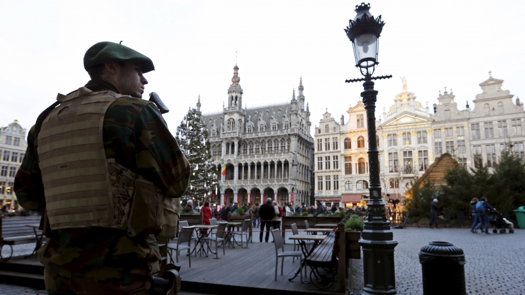 A Belgian soldier patrols Brussels Grand Place after police say they disrupted a plot to attack during New Year's Eve celebrations in Belgium