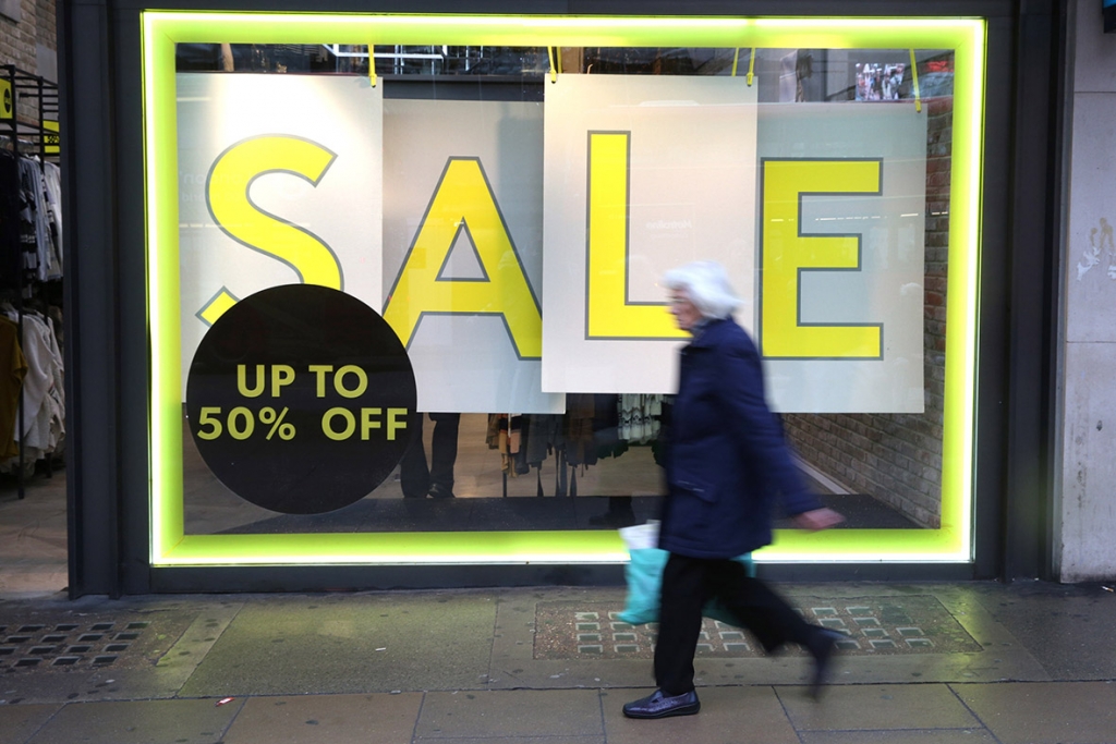 A shopper passes a sale advertisement on Oxford Street in LondonReuters