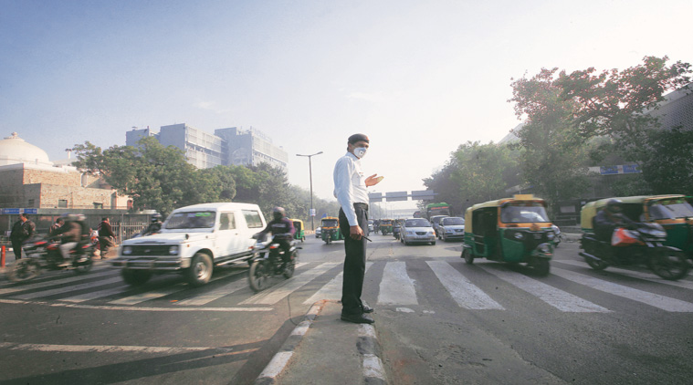 A traffic police official enforces the odd-even rule at ITO crossing