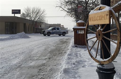 A police vehicle drives through a downtown street in Burns Oregon Friday Jan. 15 2016. As a standoff at a nearby Oregon wildlife refuge hits the two-week mark local residents are growing increasingly weary and wary