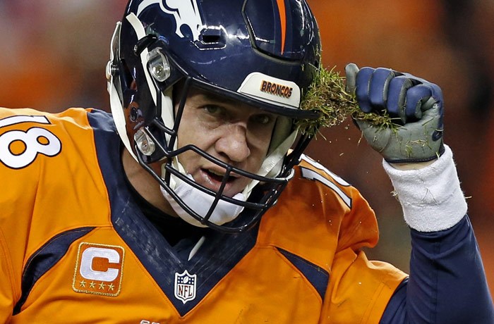 Denver Broncos quarterback Peyton Manning pulls grass off his helmet during the second half in an NFL football game against the San Diego Chargers Sunday Jan. 3 2016 in Denver