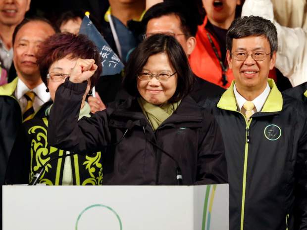 Taiwan's Democratic Progressive Party DPP presidential candidate Tsai Ing-wen raises her hand as she declares victory in the presidential election Saturday Jan. 16 2016 in Taipei Taiwan. AP