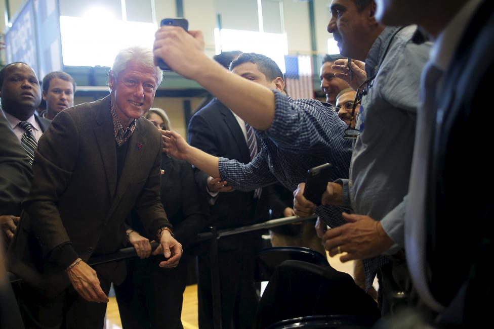 A dialed-down Bill Clinton returns to New Hampshire as the proud husband