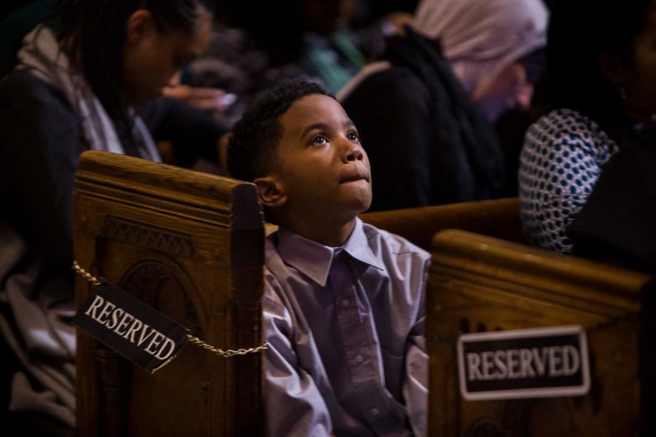 A child listens to a speech during an event celebrating the life and legacy of the Rev. Martin Luther King Jr. at the Riverside Church in New York Monday Jan. 18 2016. The event organizers said was meant not only to celebrate King's legacy but also