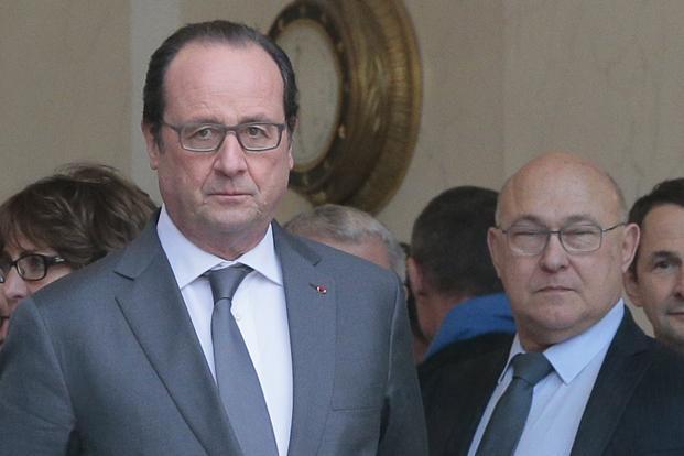 Francois Hollande along with finance minister Michel Sapin