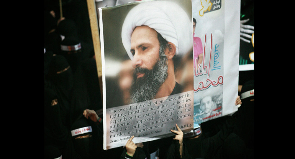 Saudi anti-government protester carries a poster with the image of jailed Shiite cleric Sheik Nimr al Nimr during the funeral of three Shiite Muslims allegedly killed by Saudi security forces in the east