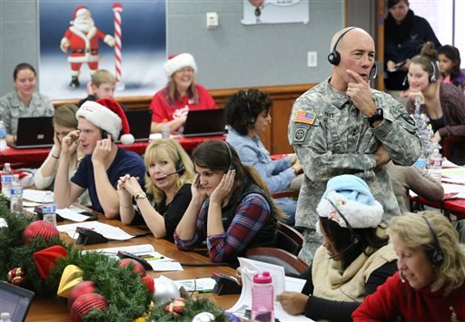 NORAD and U.S. Northern Command Chief of Staff Maj. Gen. Charles D. Luckey joins other volunteers taking phone calls from children around the world asking where Santa is and when he will deliver prese