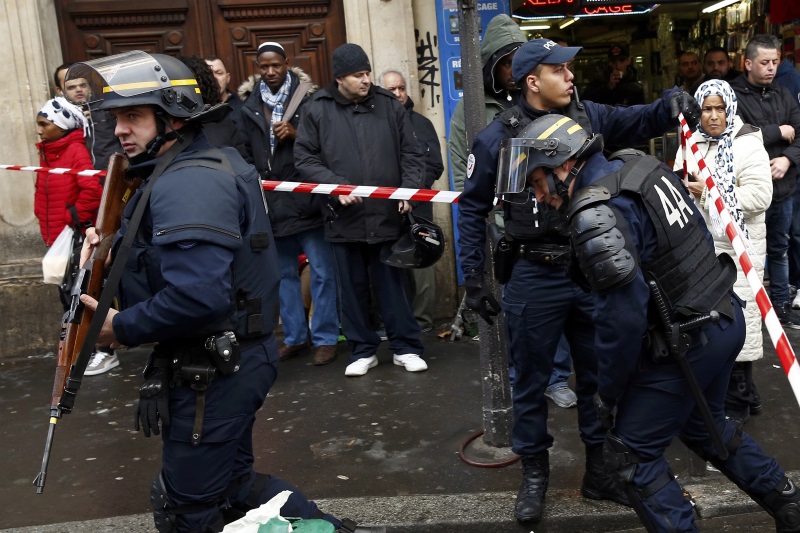 French police secure the area after a man was shot dead at a police station in the 18th district in Paris