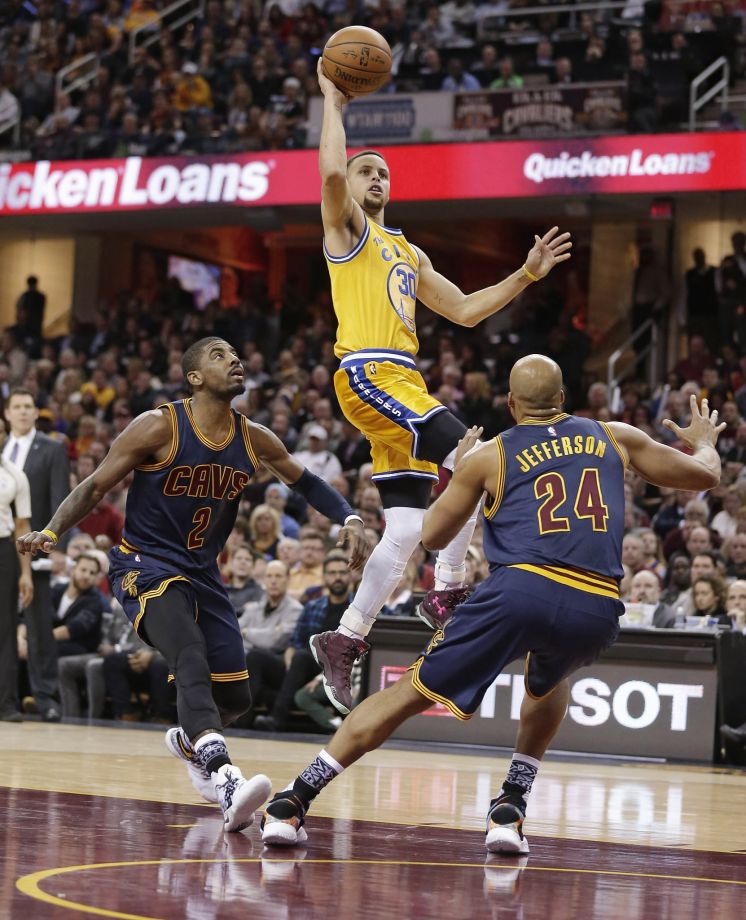 Stephen Curry who had 35 points in 28 minutes rises above Cleveland defenders Kyrie Irving and Richard Jefferson