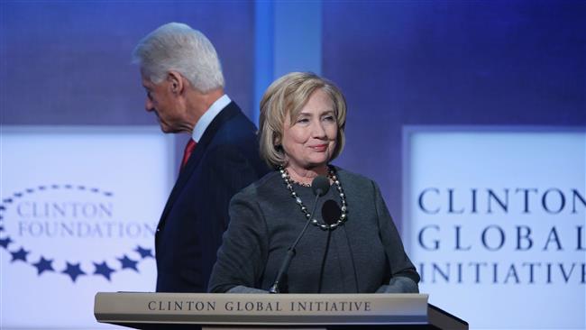 Former US President Bill Clinton leaves the stage as his wife Hillary Clinton prepares to speak at the 2015 meeting of the Clinton Global Initiative at the University of Miami in Florida