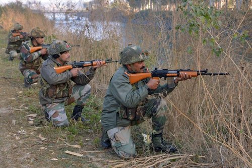 Indian soldiers take up positions on the perimeter of an airforce base in Pathankot