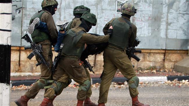 Israeli soldiers carry a Palestinian after he was detained during clashes in the West Bank city of Bethlehem