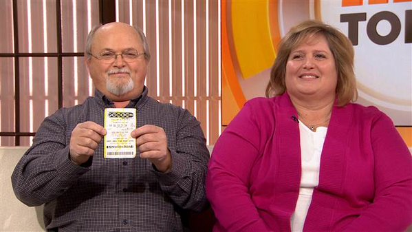 John Robinson and his wife Lisa with what they claim is the winning Powerball lottery ticket on Jan. 15 2016