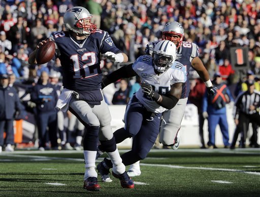 New England Patriots quarterback Tom Brady passes against pressure from Tennessee Titans linebacker Brian Orakpo in the first half of an NFL football game Sunday Dec. 20 2015 in Foxborough Mass