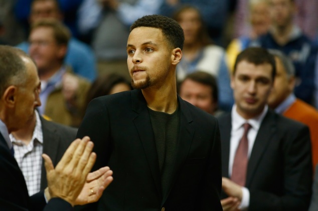 Stephen Curry of the Golden State Warriors seen on the bench during a NBA game against the Dallas Mavericks at American Airlines Center in Dallas Texas