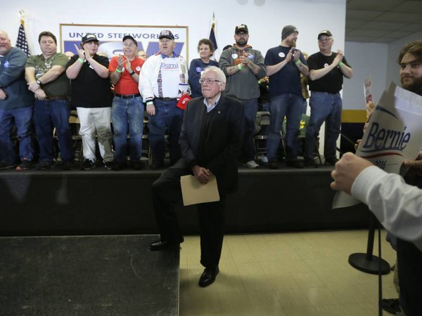 Democratic presidential candidate Sen. Bernie Sanders I-Vt. listens as he is introduced to speak at a stop at the United Steelworkers Local 310L union hall Tuesday Jan. 26 2016 in Des Moines Iowa