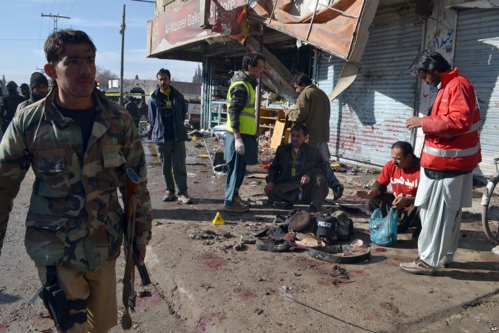 Pakistani police officers and rescue workers gather at the site of suicide bombing in Quetta Pakistan Wednesday Jan. 13 2016