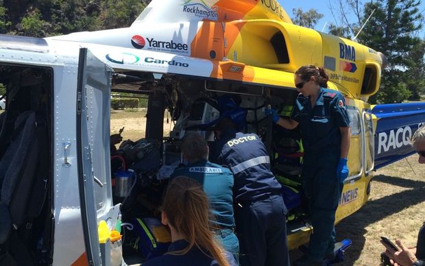 Paramedics treat the 31-year-old man who was attacked by a shark while spearfishing off Yeppoon in central Queensland