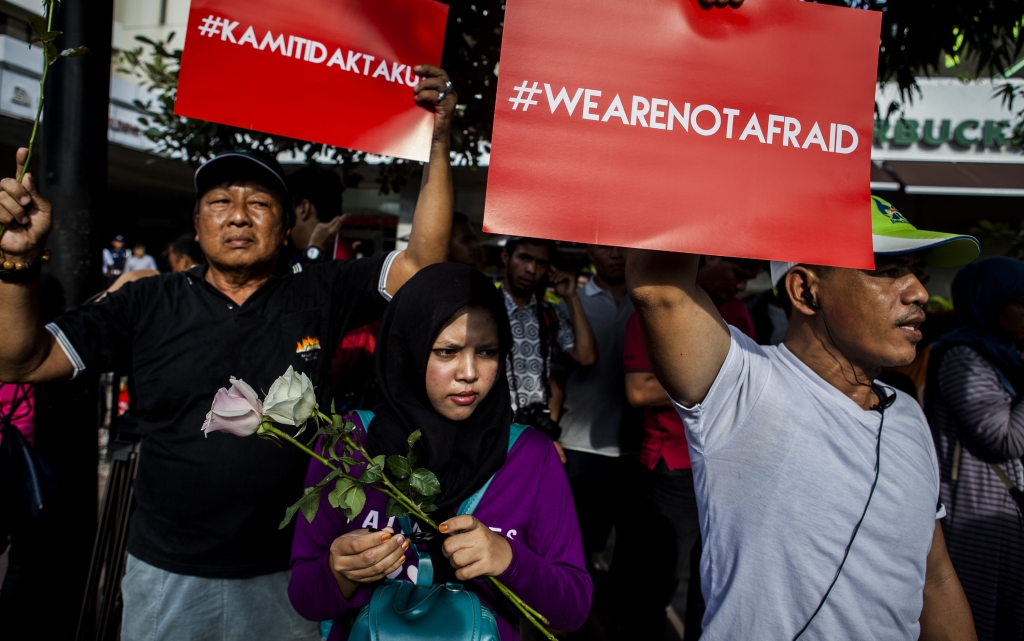 People hold placards reading'We Are Not Afraid during a rally held one day after the terrorist attack in Jakarta