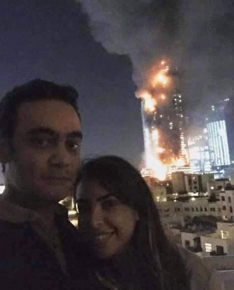 Couple pose for 'most inappropriate selfie ever&#039 in front of Dubai skyscraper fire