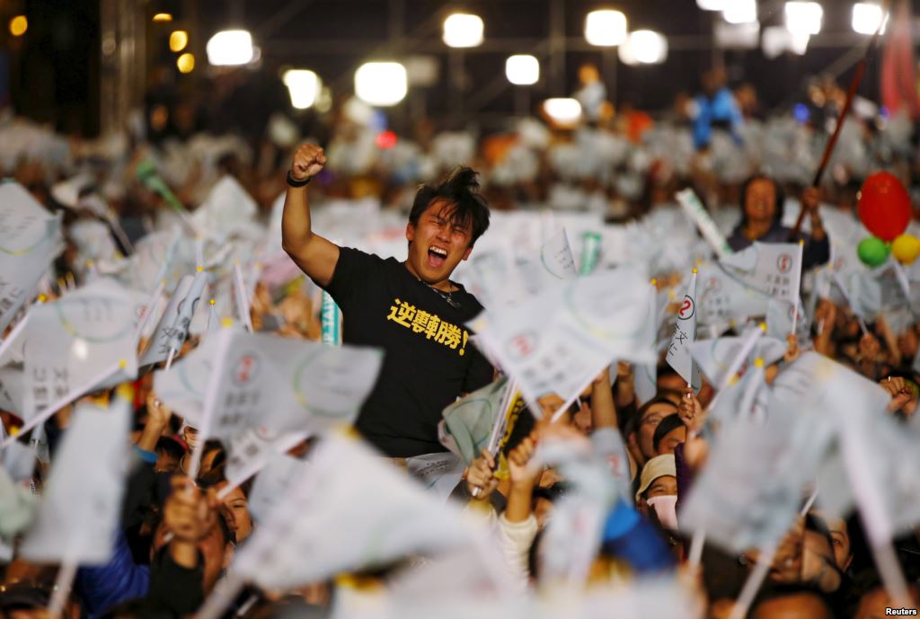 A supporter of Democratic Progressive Party Chairperson and presidential candidate Tsai Ing-wen celebrates to preliminary results at their party headquarters in Taipei Taiwan Jan. 16 2016