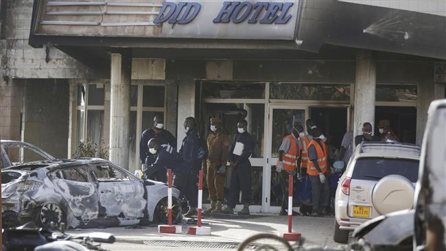 Rescue workers carry a body from the Splendid Hotel in Ouagadougou Burkina Faso