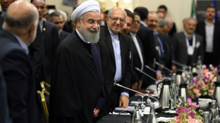 Iranian President Hassan Rouhani attends a meeting with French ministers and representatives of the Movement of the Enterprises of France in Paris