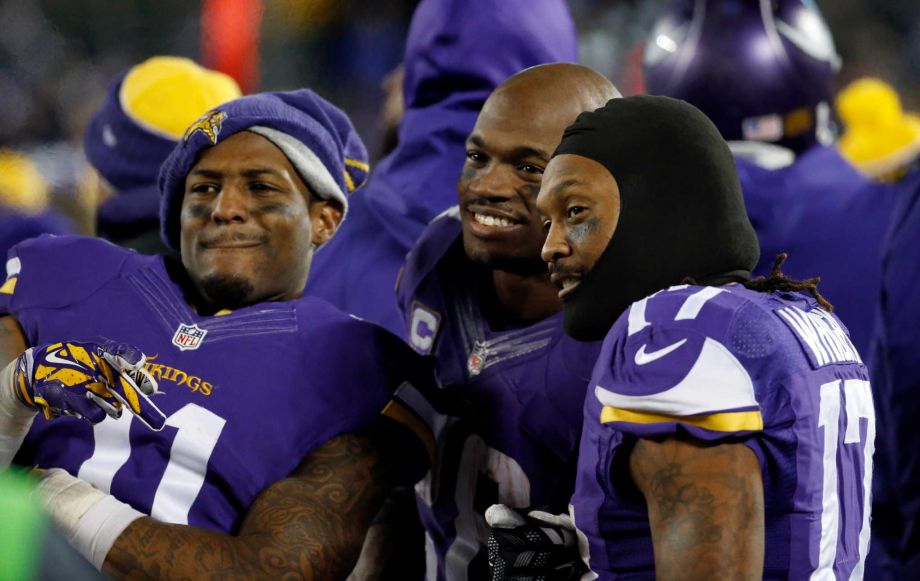 Minnesota Vikings wide receiver Mike Wallace, running back Adrian Peterson and wide receiver Jarius Wright react on the sideline during the second half of an NFL football game against the New York G