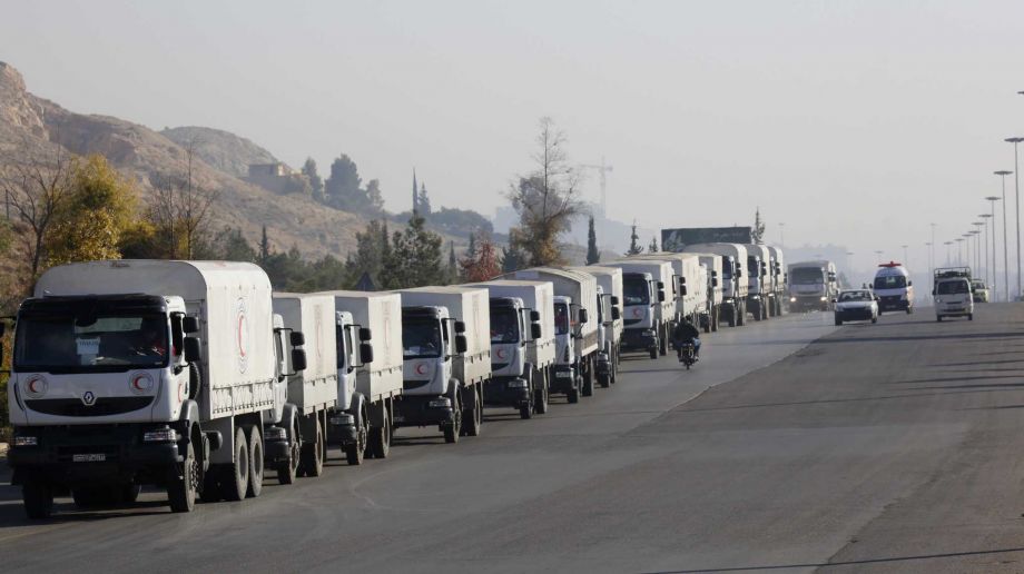 A convoy of trucks loaded with humanitarian supplies are seen heading to the besieged town of Madaya some 24 kilometers in southwest Damascus Syria on Thursday Jan. 14 2016 for distribution as part of a large-scale U.N.-sponsored aid operation in the