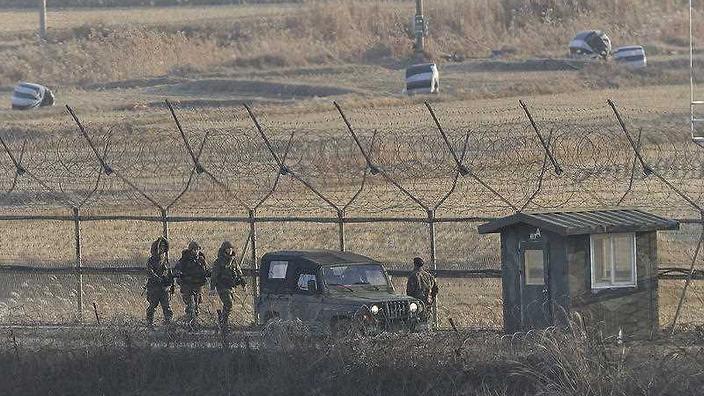 South Korean army soldiers patrol along the barbed-wire fence in Paju near the border with North Korea