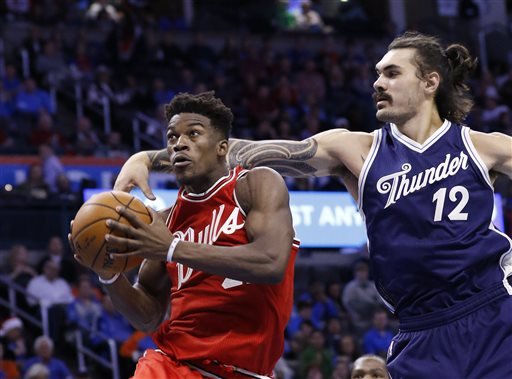 Chicago Bulls guard Jimmy Butler left goes to the basket ahead of Oklahoma City Thunder center Steven Adams during the third quarter of an NBA basketball game in Oklahoma City Friday Dec. 25 2015. Chicago won 105-96