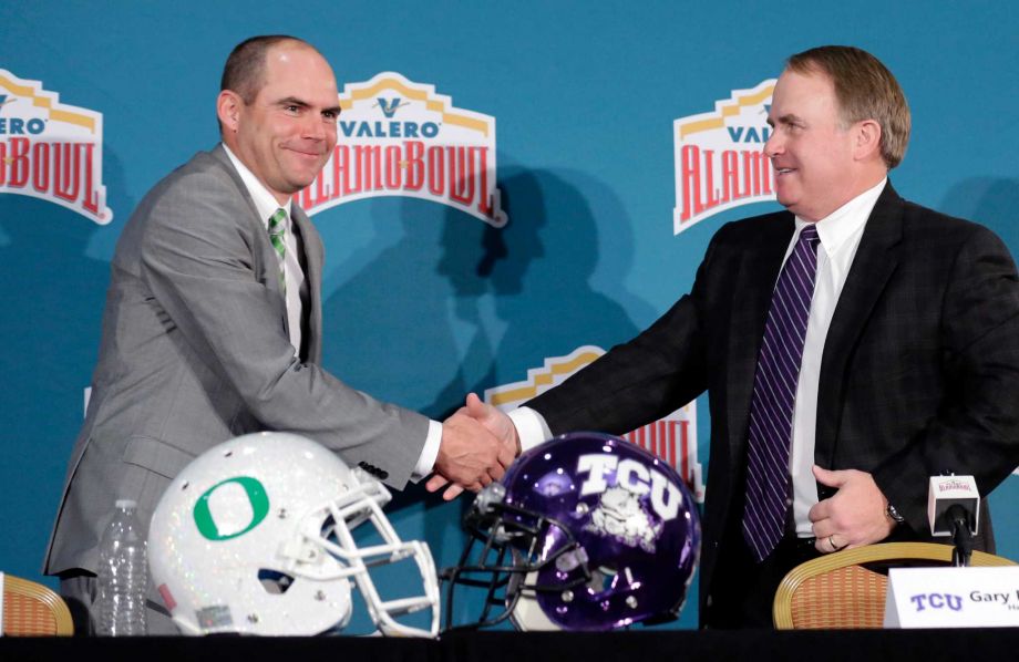 Oregon head coach Mark Helfrich left and TCU head coach Gary Patterson right shake hands following a news conference for the Alamo Bowl NCAA college football game Friday Jan. 1 2016 in San Antonio. The two teams meet on Saturday. (AP