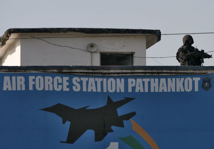 An Indian security personnel stands guard on a building at the Indian Air Force base at Pathankot in Punjab