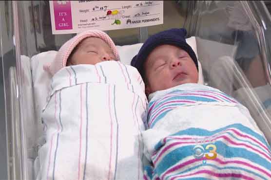 These brand new twins may be physically close- but there's a whole year between them