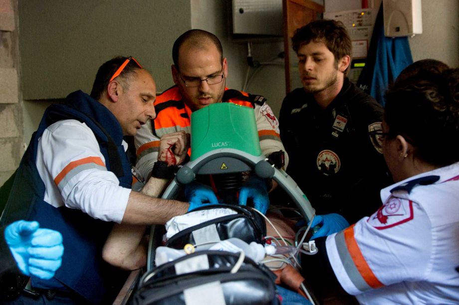 Israeli medics tend to a wounded person at the scene of a shooting attack that killed two people in Tel Aviv Israel on Friday