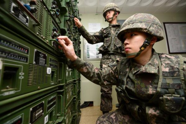 South Korean army soldiers adjust equipment used for