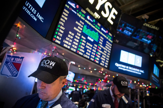 NEW YORK NY- DECEMBER 23 Traders wear hats that say'DOW 18,000 as they work on the floor of the New York Stock Exchange during the afternoon