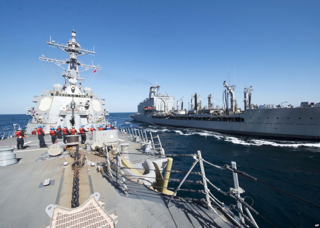 FILE- Guided-missile destroyer USS Bulkeley participates in a replenishment-at-sea with fleet replenishment oiler USNS John Lenthall in the Gulf of Oman. Iranian naval vessels conducted rocket tests last week near the USS Harry S. Truman aircraft carrier