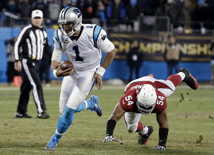 Carolina Panthers Cam Newton runs past Arizona Cardinals Kenny Demens for a first down during the second half the NFL football NFC Championship game Sunday Jan. 24 2016 in Charlotte N.C