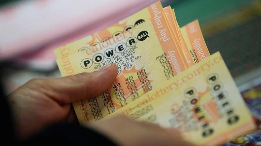 A customer buys Powerball tickets at Kavanagh Liquors