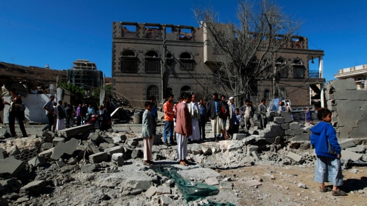 Yemenis inspect the damage following an air-strike on Sanaa