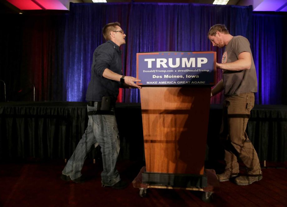 Workers takes the podium down after Republican presidential candidate businessman Donald Trump spoke at his caucus night rally Monday Feb. 1 2016 in West Des Moines Iowa