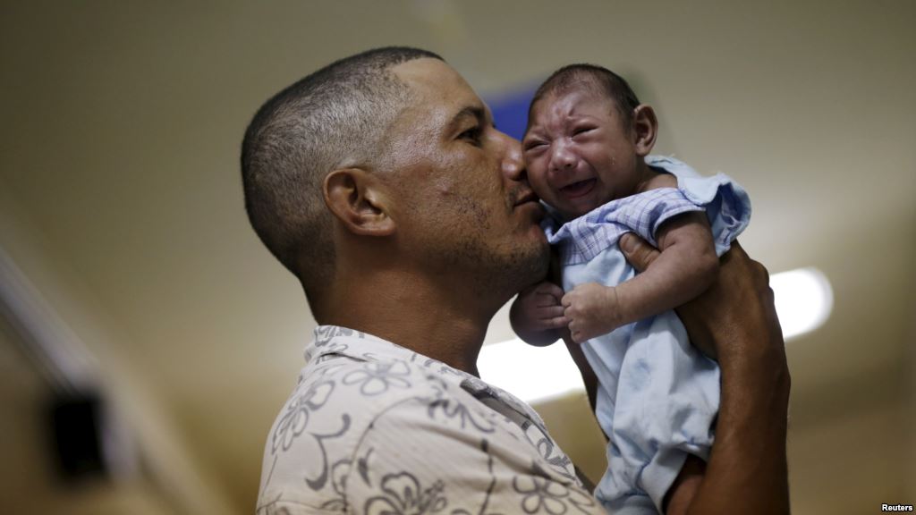 FILE- Geovane Silva holds his son Gustavo Henrique who has microcephaly at the Oswaldo Cruz Hospital in Recife Brazil Jan. 26 2016