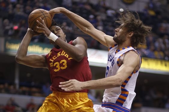 Myles Turner left is fouled by New York Knicks center Robin Lopez during the second half of an NBA basketball game in Indianapolis Wednesday Feb. 24 2016. The Pacers won 108-105