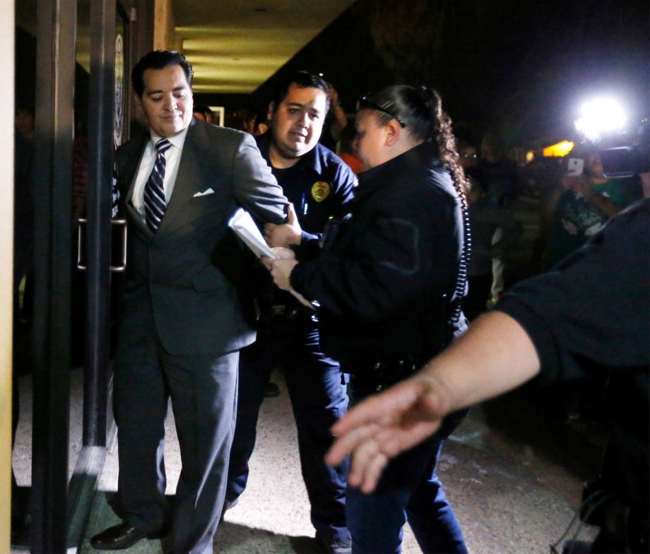 Crystal City Mayor Ricardo Lopez is taken away from city hall by police﻿ Tuesday after allegedly disrupting a City Council meeting