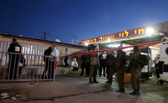 Israeli troops gather near the scene of a stabbing attack near the West Bank city of Ramallah