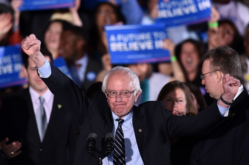 US Democratic presidential candidate Bernie Sanders reacts on stage during a primary night rally in Concord New Hampshire