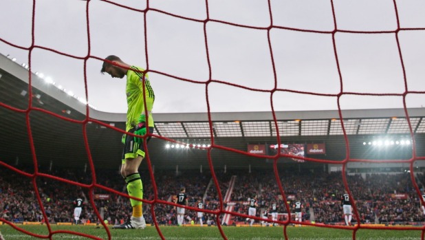 A dejected Manchester United goalkeeper David de Gea stares at the ground after his own goal results in victory for Sunderland